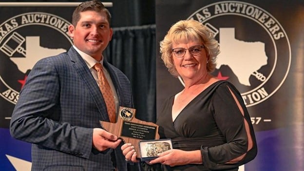 Texas Lone Star Auto Auction general manager Sara Edgington accepts her state champion auctioneer award from 2020 winner Cody Shelley. Photo courtesy of the XLerate Auction Group.